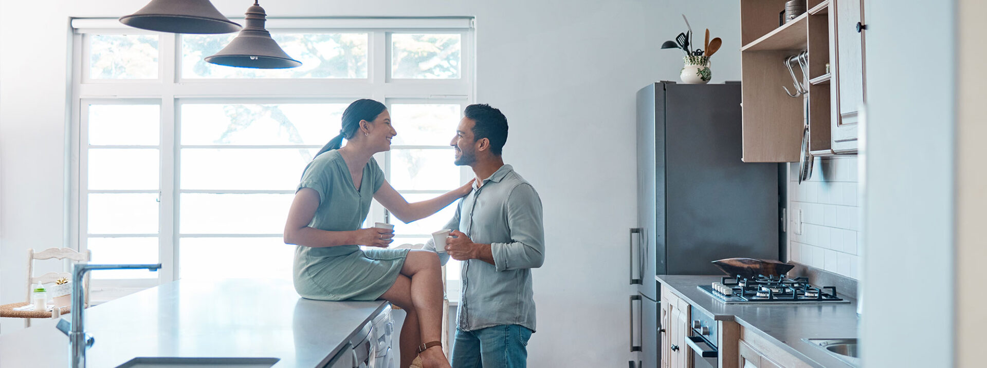 Shot of a young couple having a cup of coffee together at home